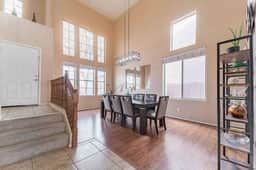 Dining area with tall windows and natural light, perfect for shared meals.