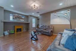 Open living area with comfortable sofas and easy flow to the kitchen and dining spaces.
