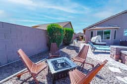 Private desert patio with fire pit, chaise loungers and cozy seating