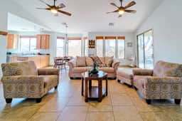 Sunny open-plan living with comfy seating and patio access
