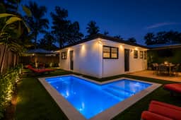 Private tropical villa with glowing pool and inviting outdoor lounge