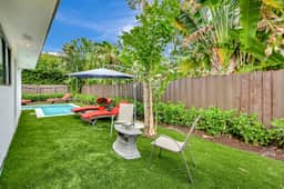 A charming outdoor seating area surrounded by greenery, perfect for morning coffee or quiet conversations. The lush setting creates a calm and refreshing atmosphere.