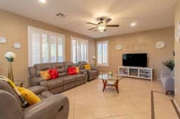 Bright, open living room with reclining sofas — perfect for relaxing together.