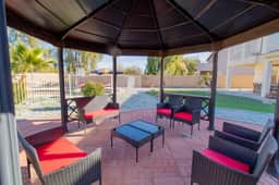 Shaded outdoor dining under the gazebo — ideal for group meals and evening hangouts.