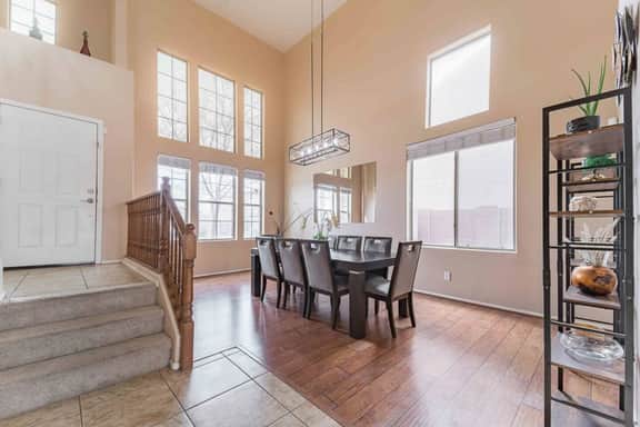 Dining area with tall windows and natural light, perfect for shared meals.