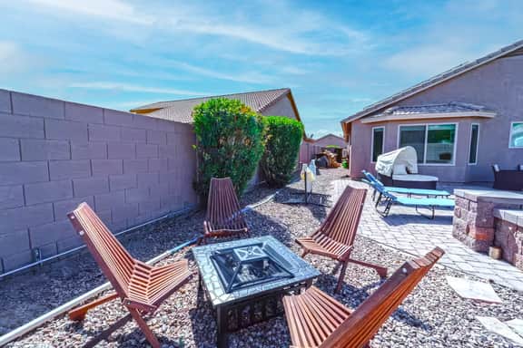 Private desert patio with fire pit, chaise loungers and cozy seating