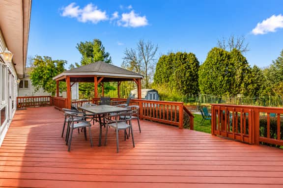 Spacious backyard deck with gazebo dining and private outdoor space