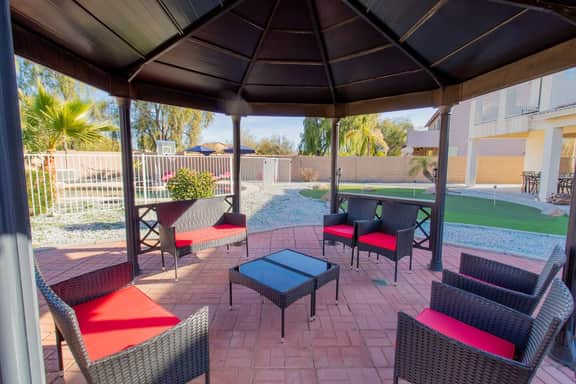 Shaded outdoor dining under the gazebo — ideal for group meals and evening hangouts.