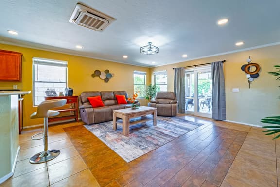 Sunny living room with recliners, coffee bar, and patio doors